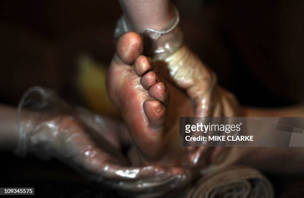Lifestyle-culture-Asia-feet,FEATURE by Adrian AddisonThis photo taken on January 31, 2011 shows a customer getting their feet massaged at a foot...