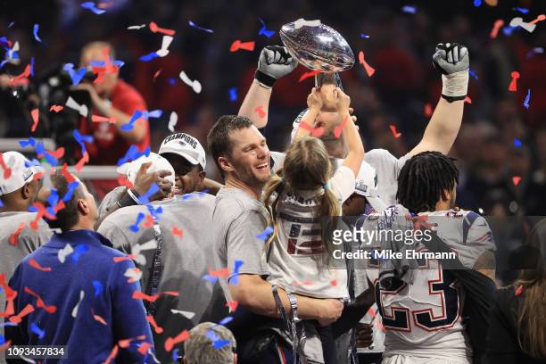 Tom Brady of the New England Patriots celebrates with daughter Vivian who raises the Vince Lombardi Trophy after Super Bowl LIII at Mercedes-Benz...