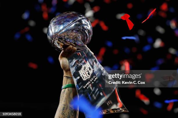Detail of a New England Patriots player raising the Vince Lombardi Trophy after the Patriots defeat the Los Angeles Rams 13-3 during Super Bowl LIII...