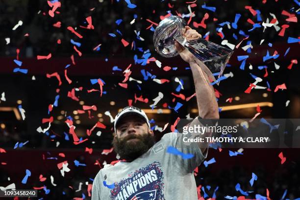 Wide receiver for the New England Patriots Julian Edelman holds the trophy as he celebrates Super Bowl LIII against the Los Angeles Rams at...