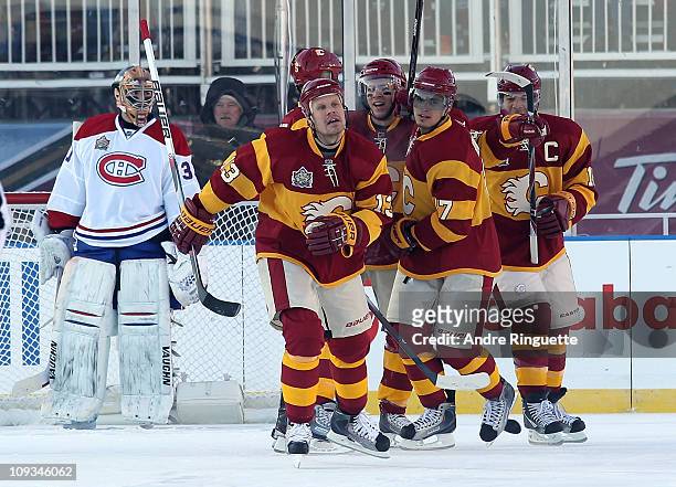 Olli Jokinen and the Calgary Flames celebrate a goal against the Montreal Canadiens during the 2011 NHL Heritage Classic Game at McMahon Stadium on...