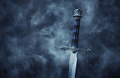 mysteriousand magical photo of silver sword over gothic snowy black background. Medieval period concept.