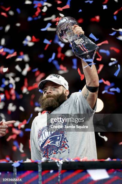 Julian Edelman of the New England Patriots raises the Vince Lombardi Trophy after the Patriots defeat the Los Angeles Rams 13-3 during Super Bowl...