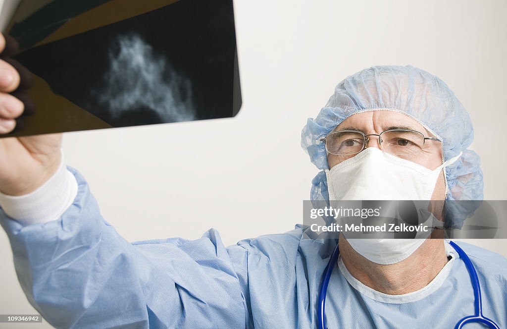 Surgeon examining mammogram x-ray