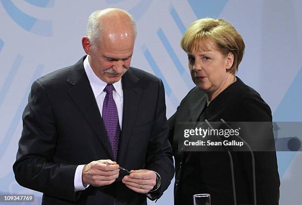 Greek Prime Minister George Papandreou and German Chancellor Angela Merkel depart after speaking to the media after talks at the Chancellery on...