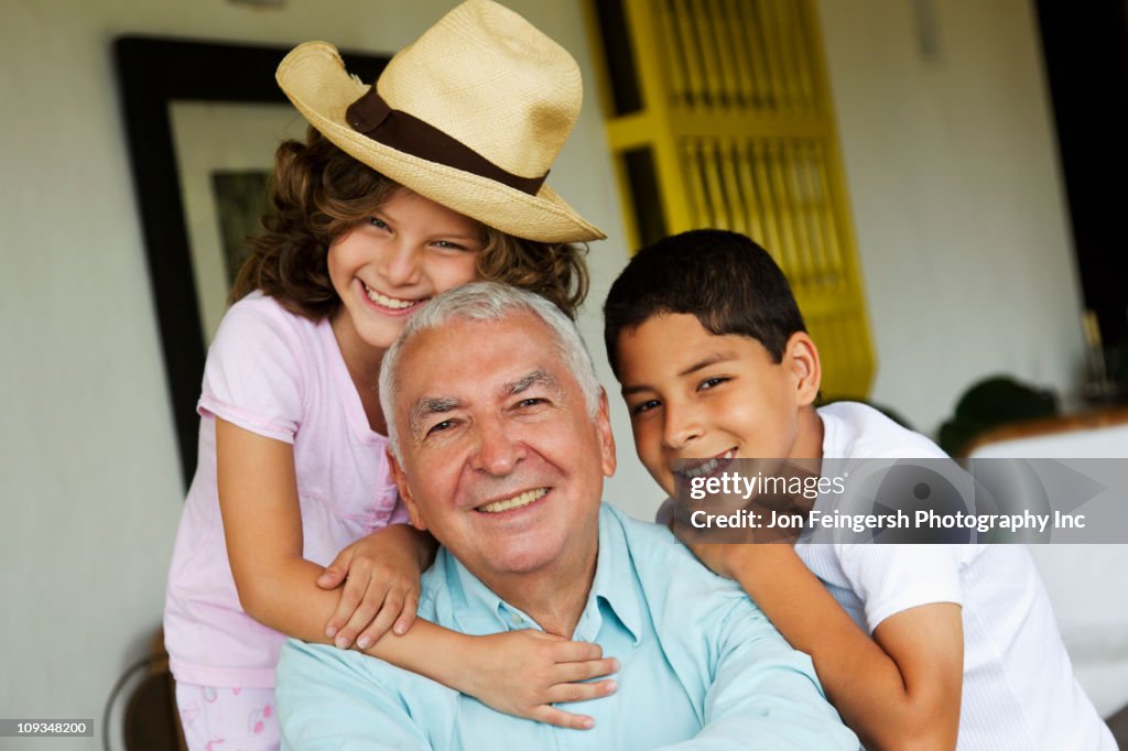 Grandchildren hugging grandfather