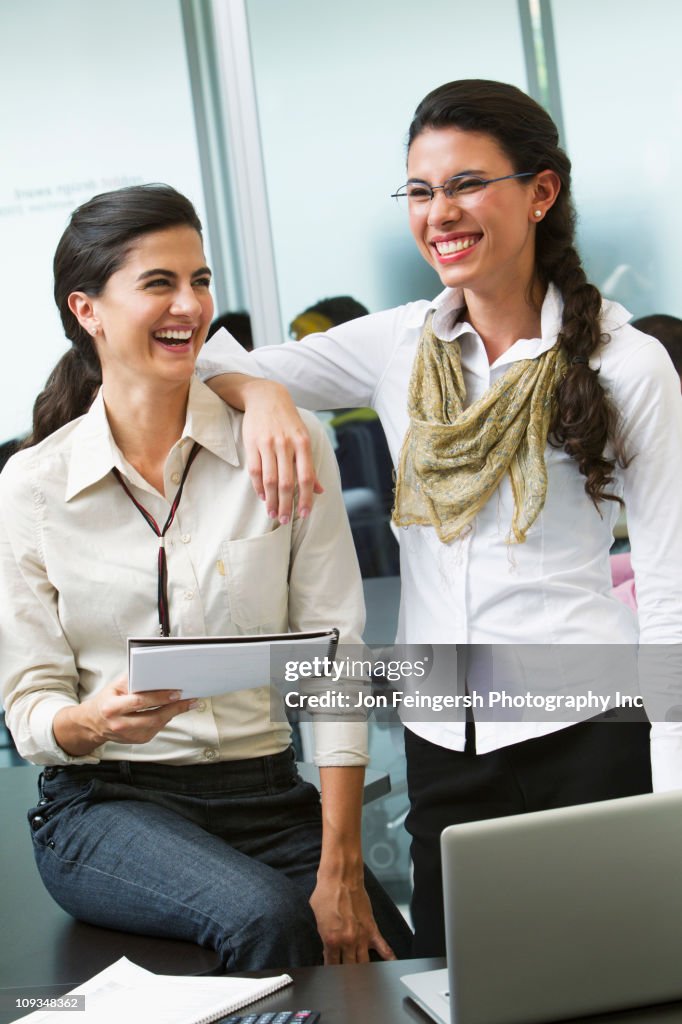 Hispanic businesswomen working together in office