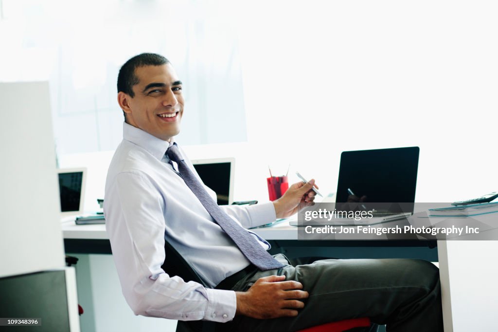 Sonriente hombre de negocios sentado en la recepción