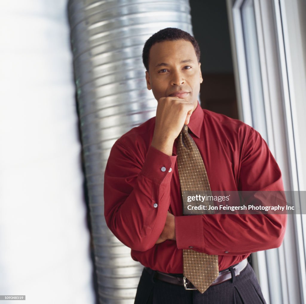 Serious businessman with hand on chin