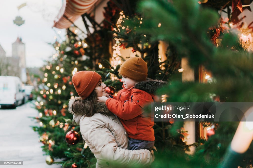 Mother with son standing near Christmas tree in Rothenburg