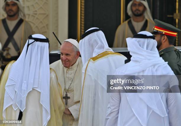 Pope Francis is welcomed by the Dubai ruler and Abu Dhabi's Crown Prince, upon his arrival to the presidential palace in the UAE capital Abu Dhabi on...