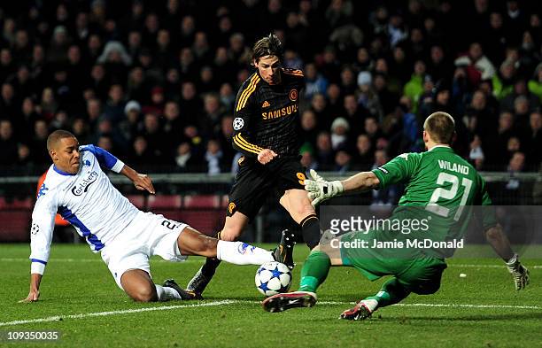 Fernando Torres of Chelsea is challenged by Mathias Zanka Jorgensen and Johan Wiland of FC Copenhagen during the UEFA Champions League round of 16...