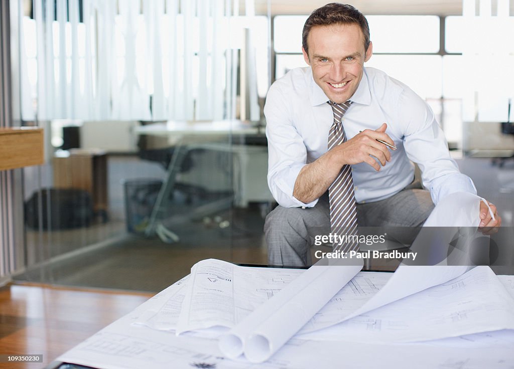 Architect reviewing blueprints in office