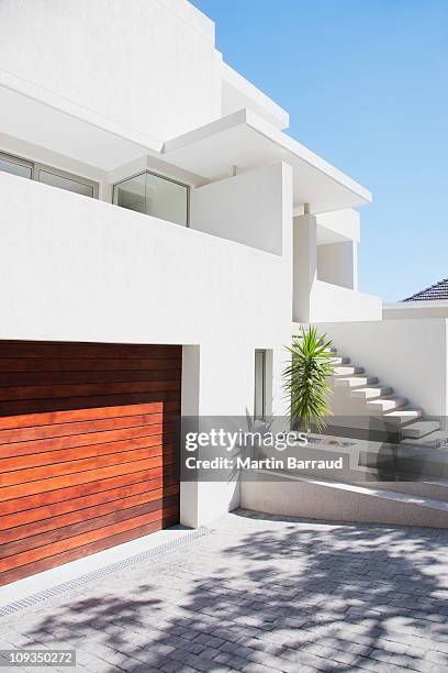 driveway and staircase of modern white house - modern garage stock pictures, royalty-free photos & images