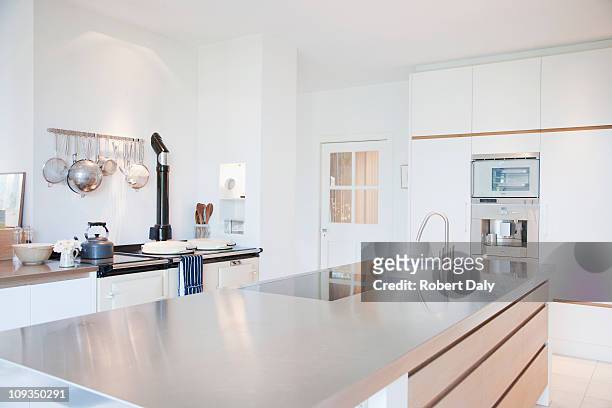modern kitchen with stainless steel counters - kitchen stockfoto's en -beelden