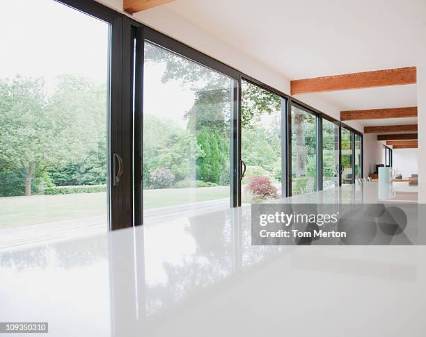 modern kitchen and glass walls to backyard - windows surface stock pictures, royalty-free photos & images
