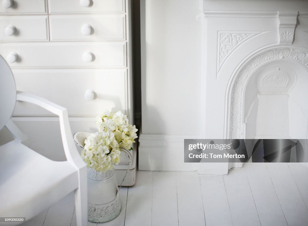 Chair and fireplace in elegant white living room