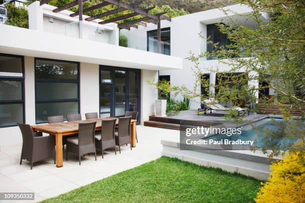 dining area next to modern house and swimming pool - bradbury house stock pictures, royalty-free photos & images