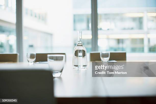 carafe and glasses on empty modern conference room in office - karaffin bildbanksfoton och bilder