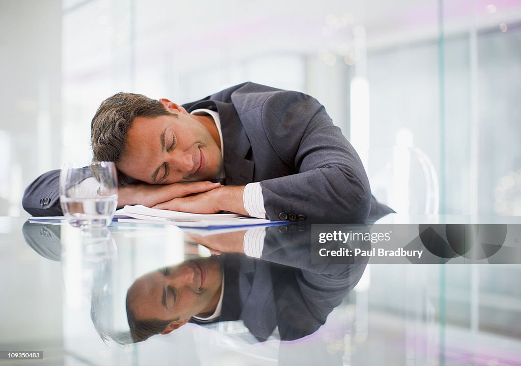 Businessman sleeping at desk in office