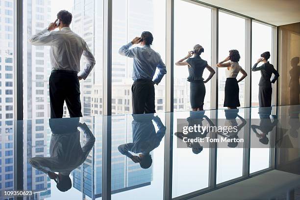 business people using cell phones in conference room - 5 funny foto e immagini stock