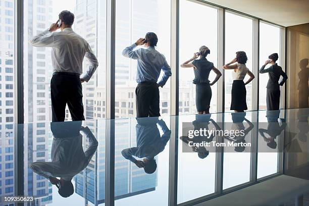 business people using cell phones in conference room - repetition stock pictures, royalty-free photos & images