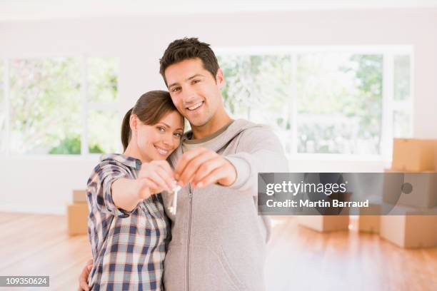 couple holding the keys to their new house - start date stock pictures, royalty-free photos & images