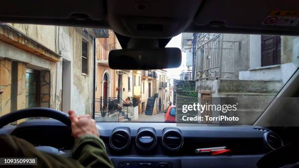 car driving on narrow street in old town - car front view stock pictures, royalty-free photos & images