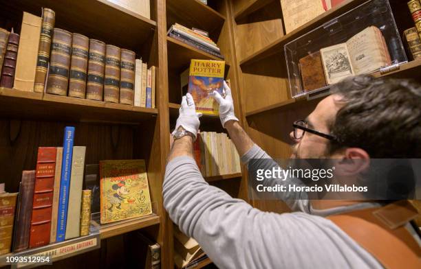 Specialist Rui Moutinho handles an autographed copy of Harry Potter and the Order of the Phoenix , at "Sala Gemma" in Lello Bookstore on the eve of...