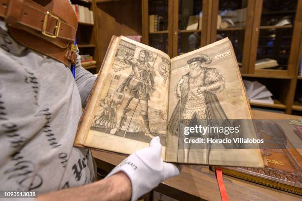 Specialist Rui Moutinho shows a copy of Os Lusiadas by Luis Vaz de Camoes at "Sala Gemma" in Lello Bookstore on the eve of its 113th anniversary on...