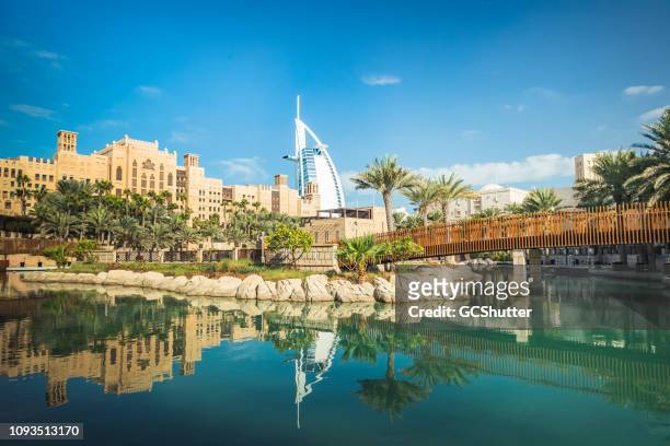 iconic burj al arab from madinat jumeirah, uae - madinat jumeirah hotel stock pictures, royalty-free photos & images