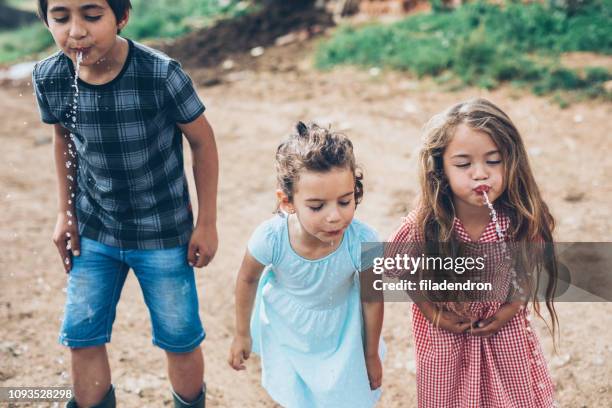 children spitting water - spats stock pictures, royalty-free photos & images