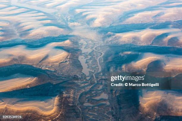 aerial view of the iced earth surface at the arctic at sunset - snow world stock pictures, royalty-free photos & images