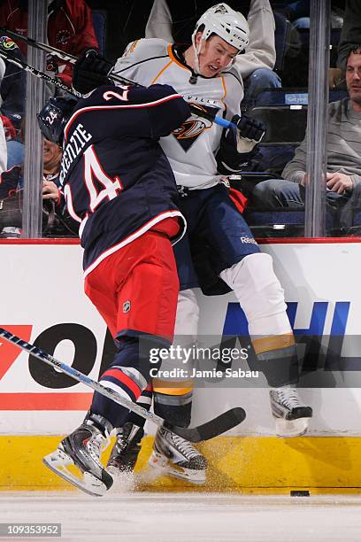 Derek MacKenzie of the Columbus Blue Jackets checks Jerred Smithson of the Nashville Predators into the boards during the first period on February...