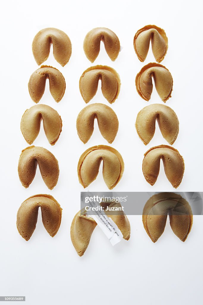 Fifteen Fortune Cookies with one open