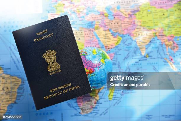 close-up of indian passport lying on world map - australia passport stockfoto's en -beelden