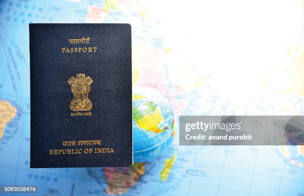 close-up of indian passport lying on world map - australia passport stockfoto's en -beelden