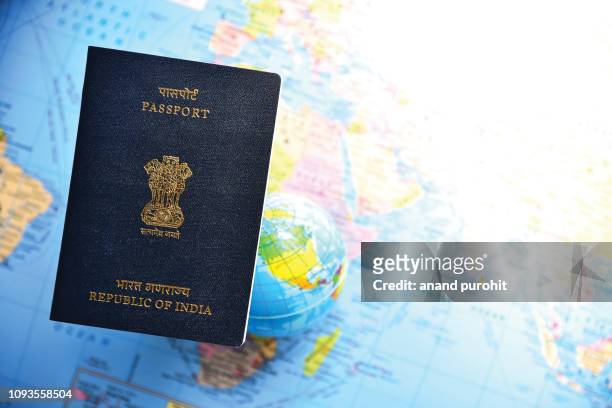 close-up of indian passport lying on world map - australia passport stockfoto's en -beelden