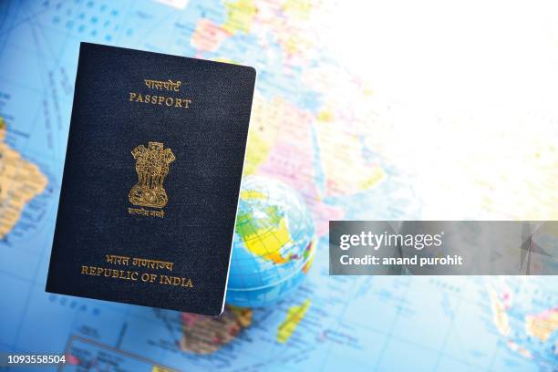 close-up of indian passport lying on world map - australian passport bildbanksfoton och bilder