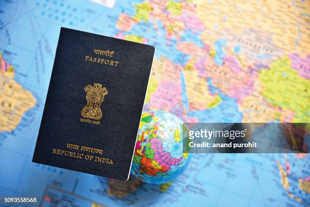 close-up of indian passport lying on world map - australian passport bildbanksfoton och bilder