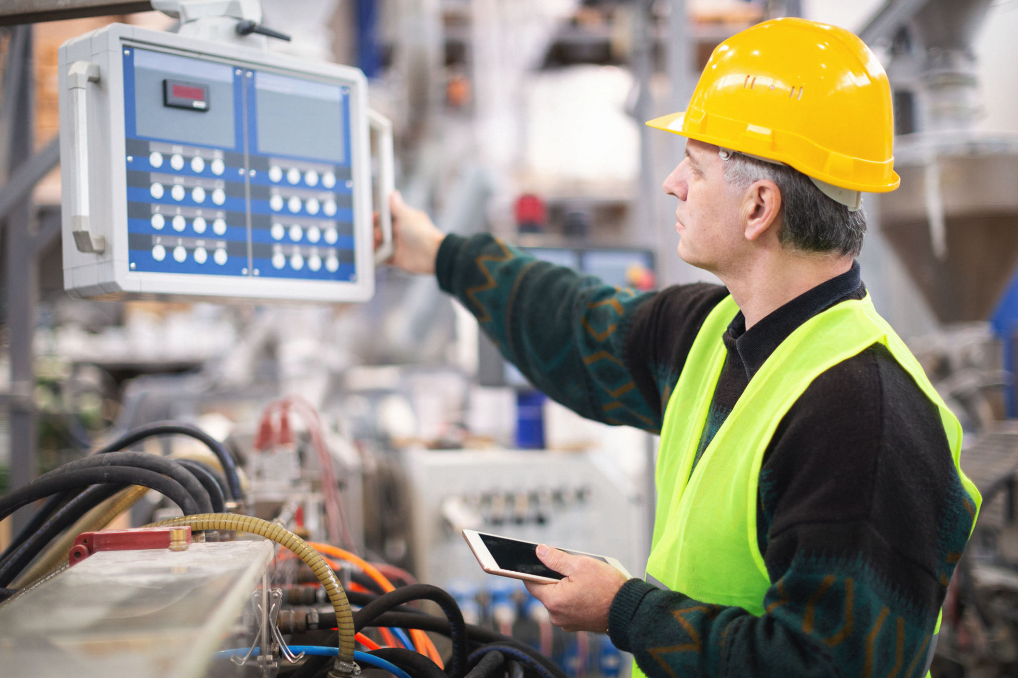 Senior worker in the factory operating machines Senior worker in the factory operating machines