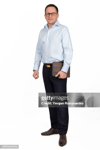 full length portrait of a young man in glasses, formal shirt and trousers with brown folder in hand, isolated on white background - formal shirt stock pictures, royalty-free photos & images