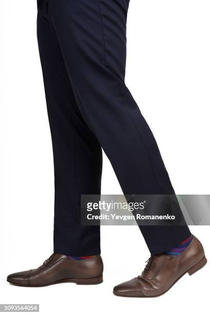 close-up of man shoes and trousers in walking position isolated on white background - black pants stockfoto's en -beelden