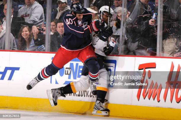 Jared Boll of the Columbus Blue Jackets gets called for charging after hitting Joel Ward of the Nashville Predators during the second period on...