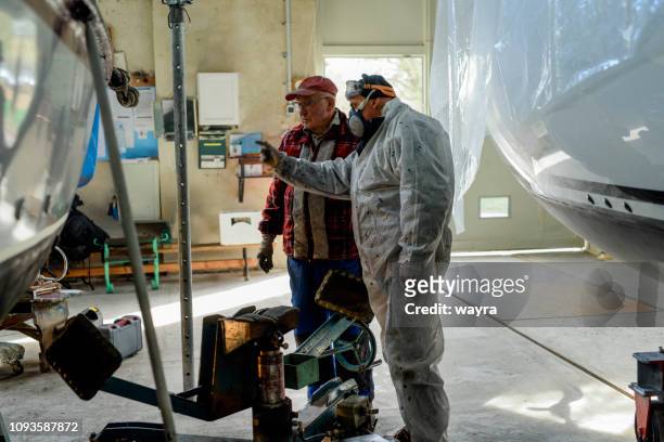 two senior man working together maintaining sailing yacht - repairing boat stock pictures, royalty-free photos & images