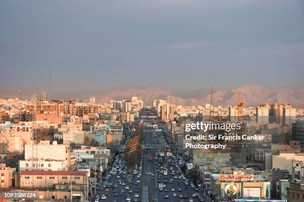 tehran skyline with prominent "azadi street" as seen from azadi tower in iran - shi'ite islam stock pictures, royalty-free photos & images