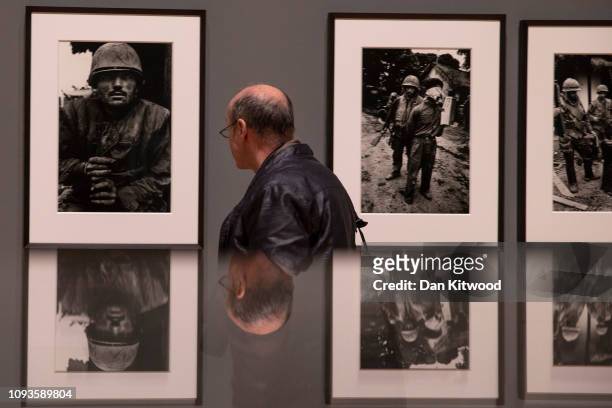 Visitors look at photographs by British photographer Sir Don McCullin during a press preview at Tate Britain on February 4, 2019 in London, England....