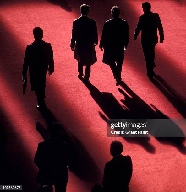 businessmen walking on red carpet. - red carpet stock pictures, royalty-free photos & images