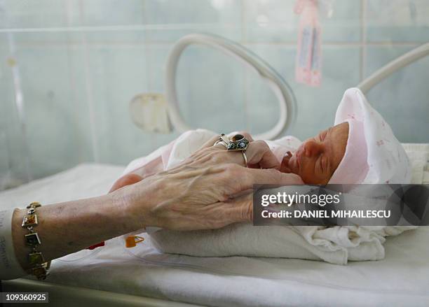 Adriana Iliescu caresses Eliza Maria, her newborn girl, at the intensive care department at the Giulesti Maternity Hospital in Bucharest, 20 January...