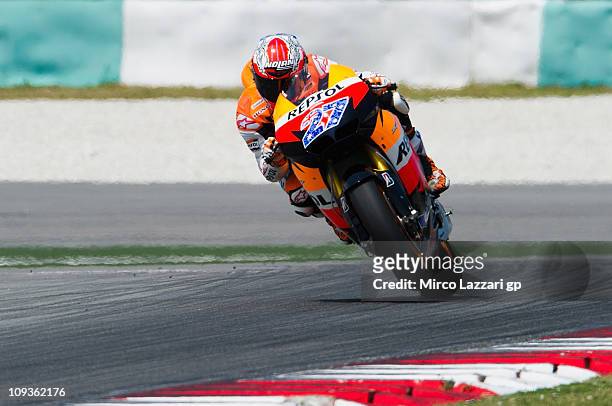 Casey Stoner of Australia and Repsol Honda Team lifts the front wheel during the second day of testing at Sepang Circuit on February 23, 2011 in...